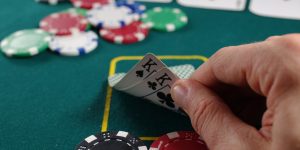 person holding white and black playing cards